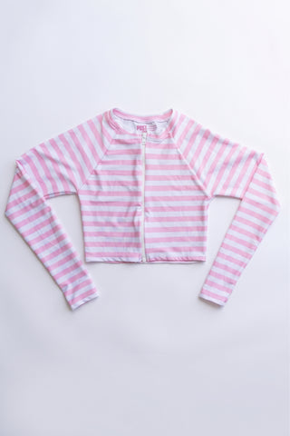 A pink and white striped long-sleeve crop top with a front zipper rash guard, factory second | POST SWIM