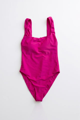 a POST SWIM bright magenta one piece bathing suit.
