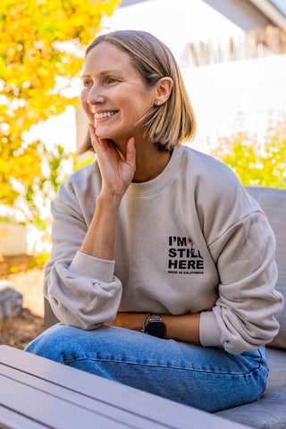 Lauren Yerkes, founder of POST SWIM, wearing the I'm Still Here Sweatshirt by POST SWIM.