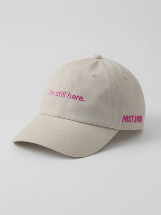 Video of the I'm Still Here Hat in stone, showing the pink 'i'm still here.' embroidery and POST SWIM logo